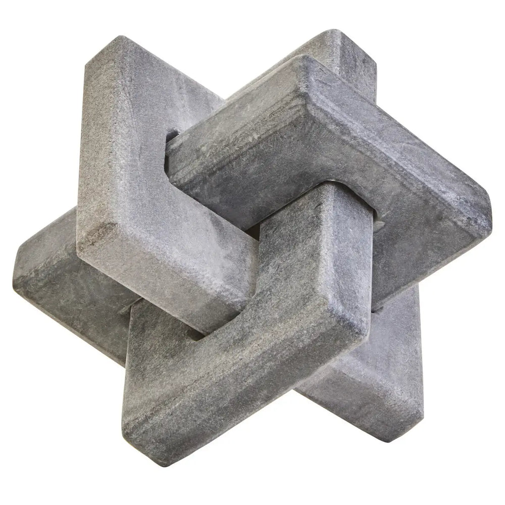 Gray concrete sculpture with interlocking geometric shapes on a white background