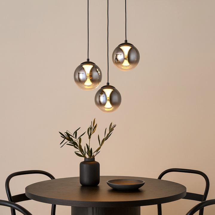 Luxury Havant 3 light smoked glass pendant above a round dining table with black accents.