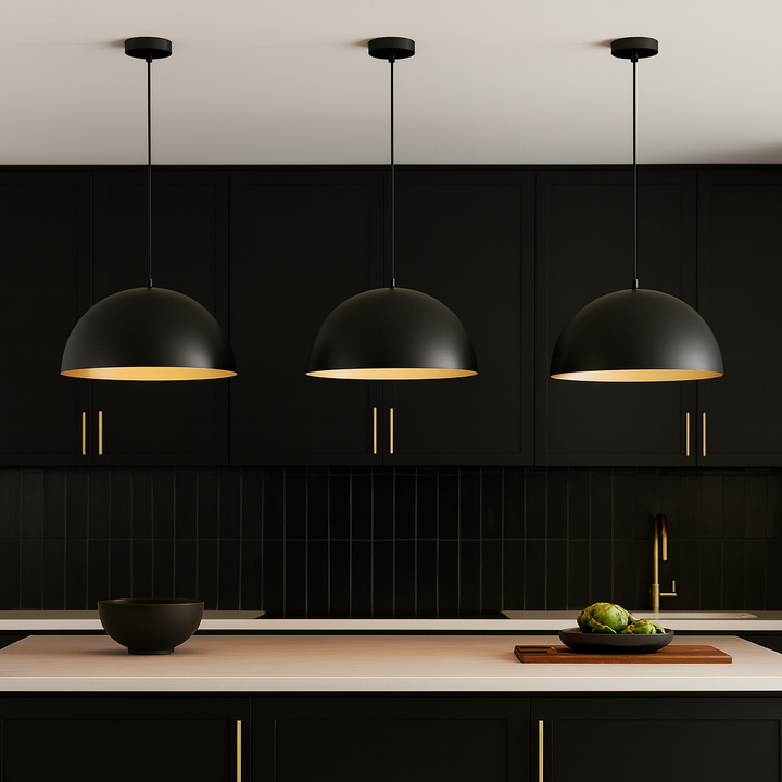 Black dome pendant lights with gold accents above modern black kitchen island