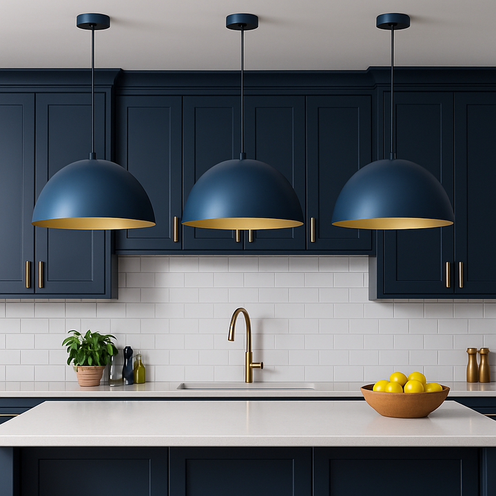 Blue dome pendant lights with gold interiors above navy kitchen island with gold accents.