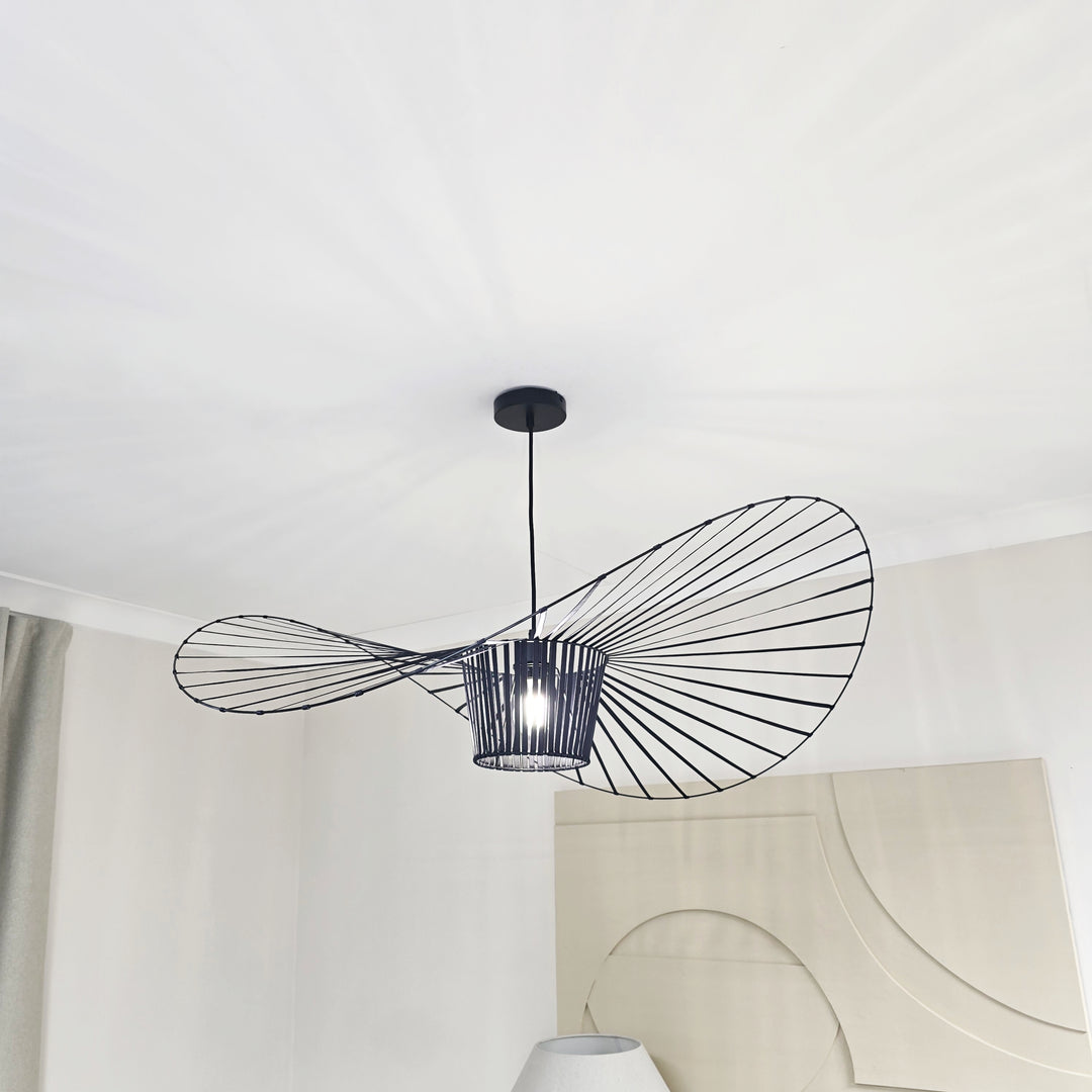 Modern pendant light with decorative black frame hanging from a white ceiling.