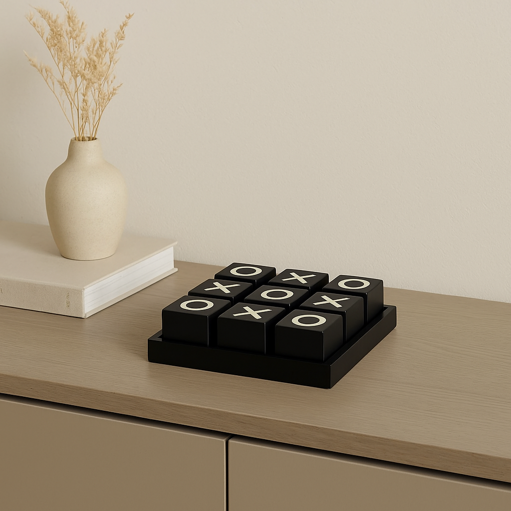 Luxury black and cream noughts and crosses set on sideboard with vase and book