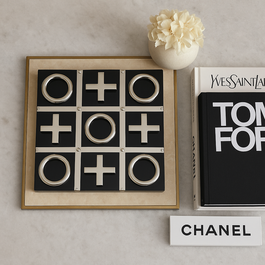 Luxury black and silver tic tac toe set on marble table with books and vase