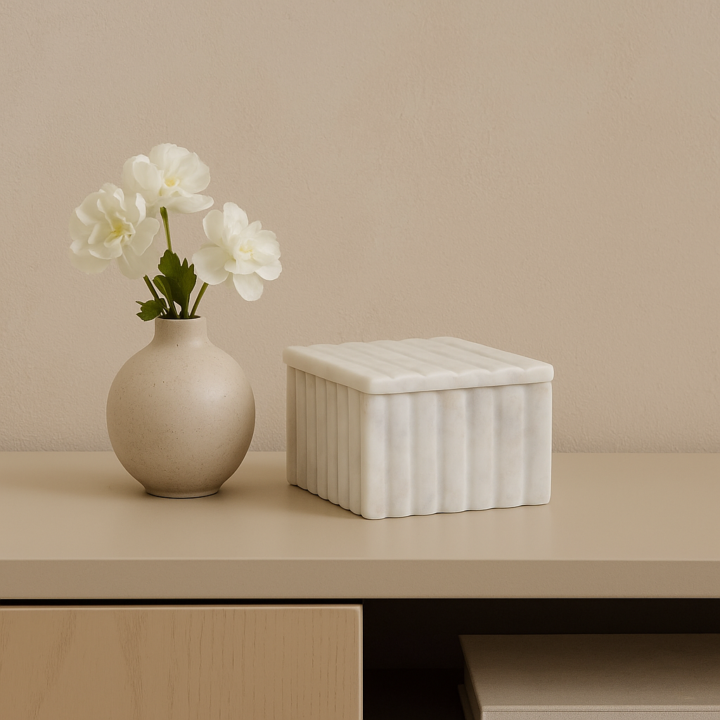 Luxury white marble box with vase of fresh white flowers on sideboard
