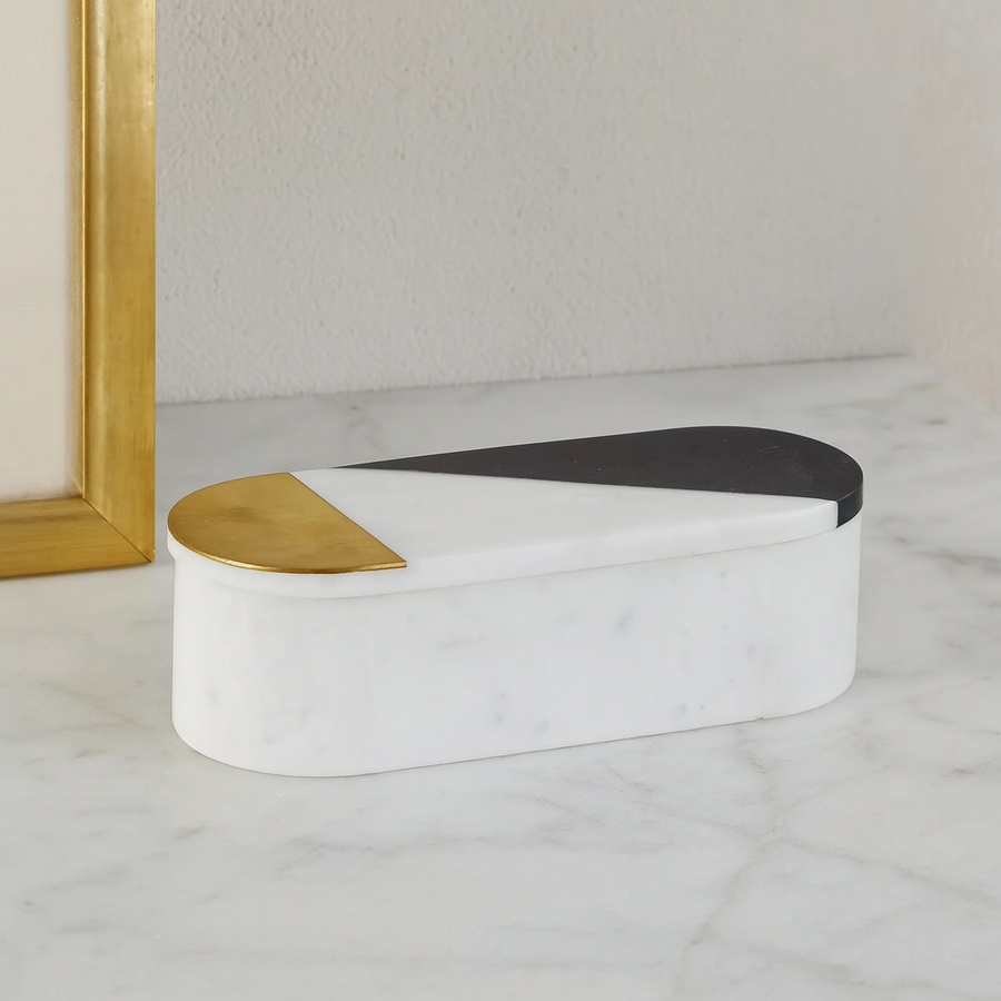 Luxury white marble decorative box with two-tone gold and black lid styled on marble surface in modern home décor