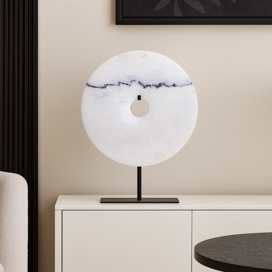 White marble disc sculpture on black stand luxury home décor accessory