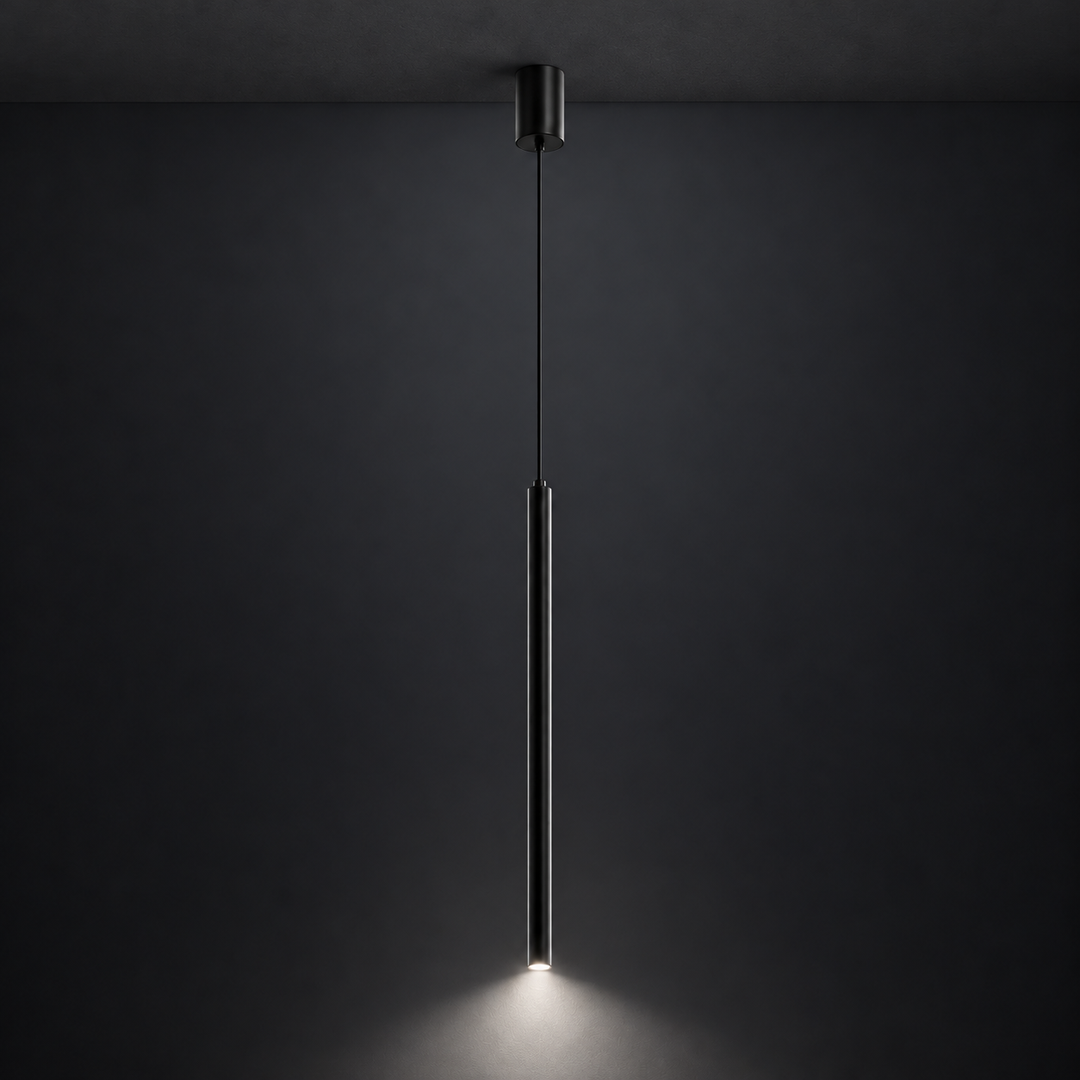 Slim black cylinder pendant mounted to a charcoal ceiling, showing its 4000K white downward illumination against a dark background.