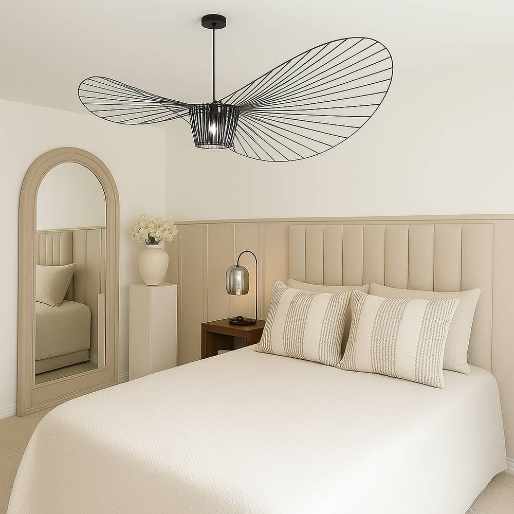 Modern black ceiling light in a neutral luxury bedroom with upholstered headboard