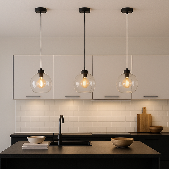 Modern kitchen with black accents featuring three 25cm clear glass pendant lights hanging above an island