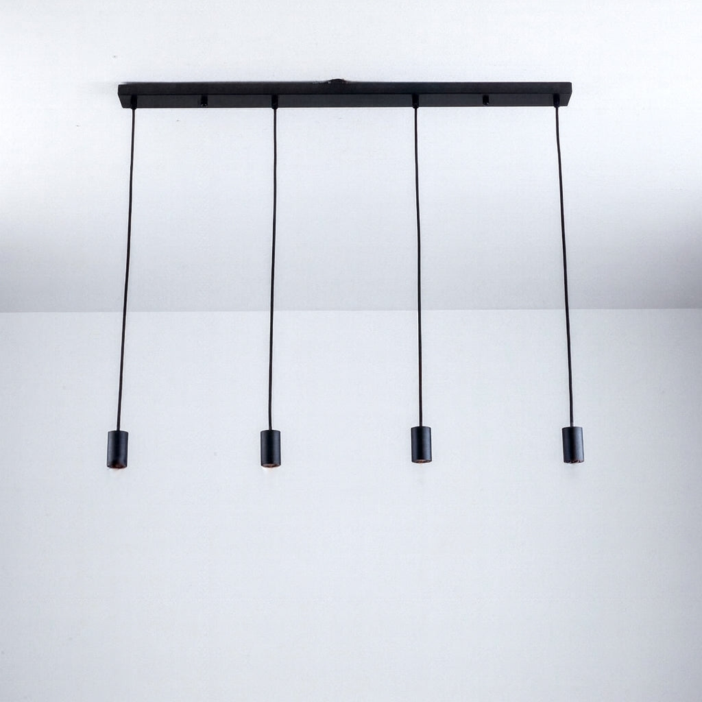 Roma 4 light black pendant bar with slim cylindrical caps and adjustable cables, shown without bulbs.
