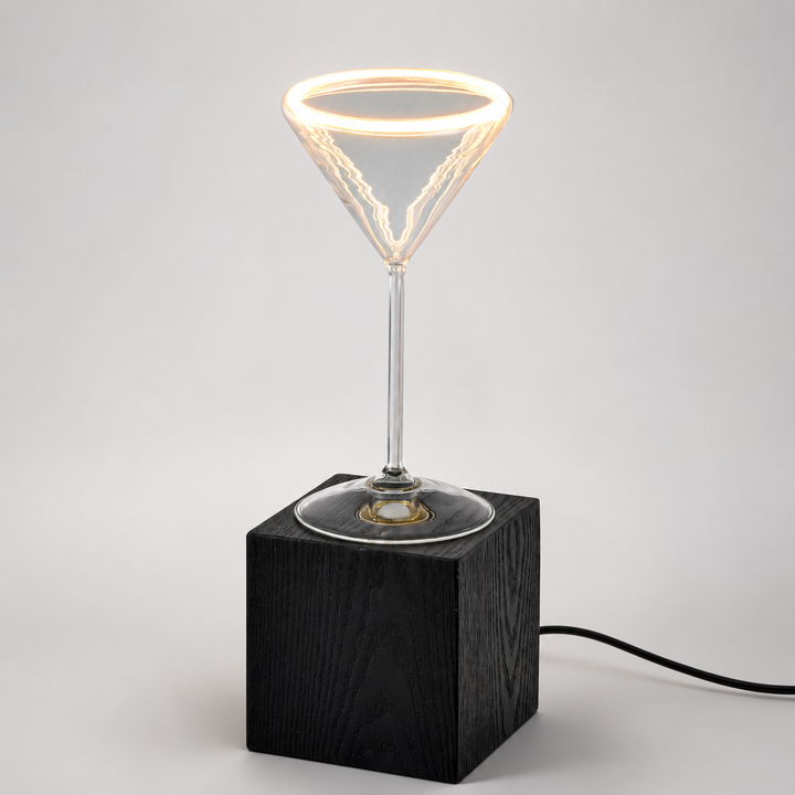 Roma Cocktail Glass Aura Ring table lamp with black wooden block base, illuminated clear glass bulb