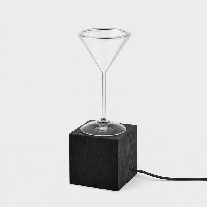 Roma Cocktail Glass Aura Ring table lamp with clear cocktail glass bulb, black wood block base and black power cable, shown unlit.