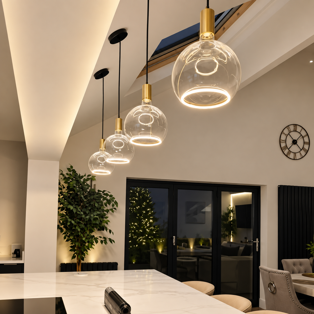 Roma single pendant lights with clear Aura LED bulbs installed on a sloped kitchen ceiling