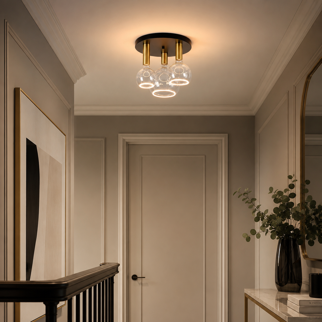 Roma small 3 light flush ceiling light with black ceiling plate, gold holders and clear Roma Aura bulbs in a luxury hallway setting.