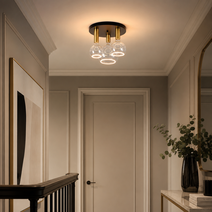 Roma small 3 light flush ceiling light with black ceiling plate, gold holders and clear Roma Aura bulbs in a luxury hallway setting.