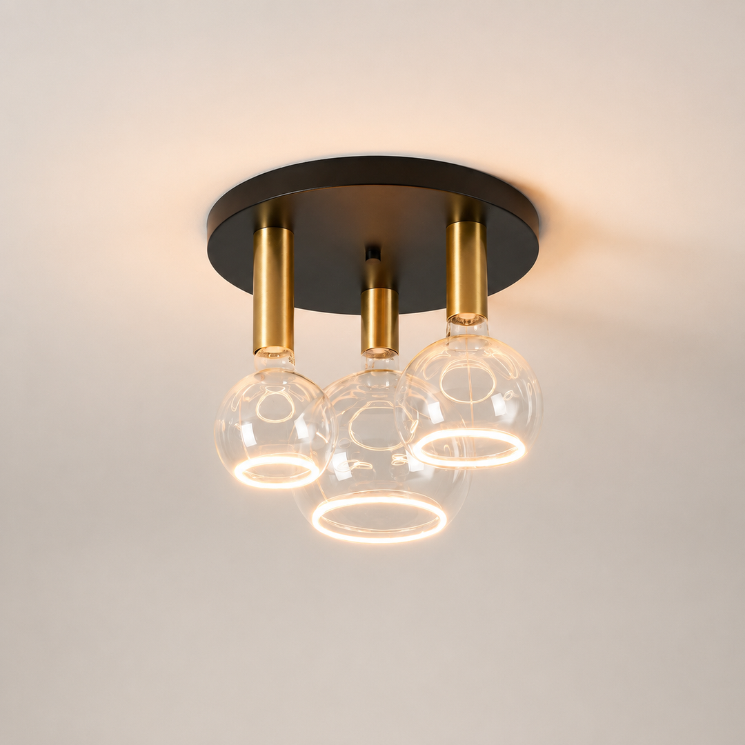 Roma small 3 light flush ceiling light with black ceiling plate, gold holders and clear Roma Aura bulbs in a luxury square hero image.