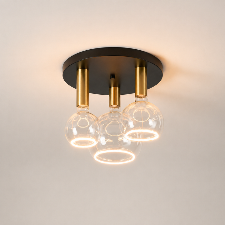 Roma small 3 light flush ceiling light with black ceiling plate, gold holders and clear Roma Aura bulbs in a luxury square hero image.