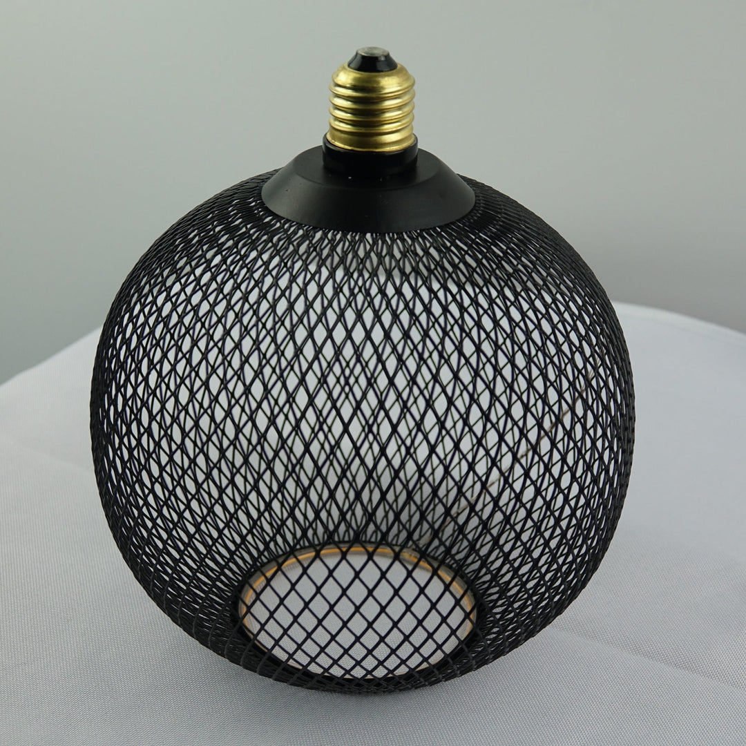 Black mesh light fixture on a white surface with a gray background