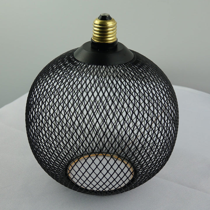Black mesh light fixture on a white surface with a gray background
