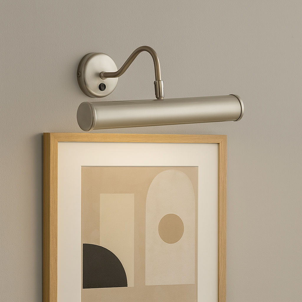 Satin silver picture wall light illuminating framed abstract geometric artwork on a grey wall