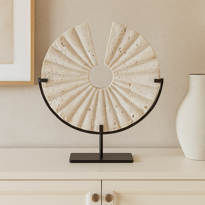 Travertine fan sculpture on cream sideboard in Scandi living room