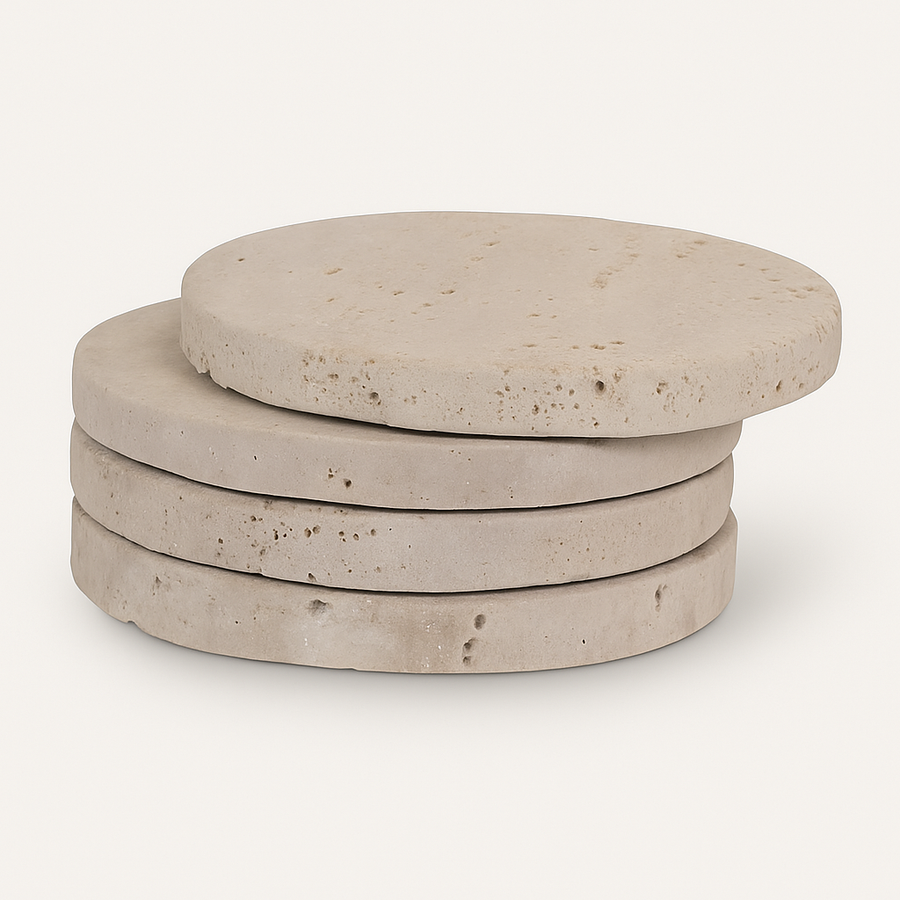 Stack of four round travertine coasters in natural beige stone with textured surface and smooth edges, displayed on a clean white background.