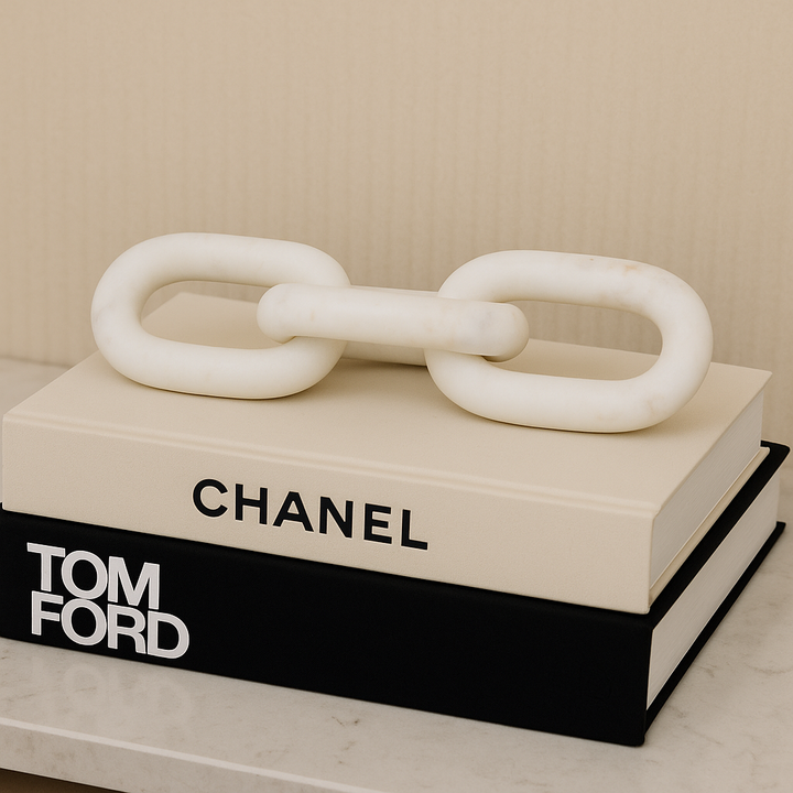 White marble chain link sculpture styled on Chanel and Tom Ford coffee table books for a luxury modern décor look.