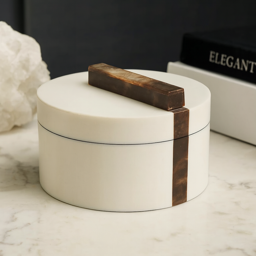 Luxury white round trinket box with brown marble effect handle styled on marble table with books
