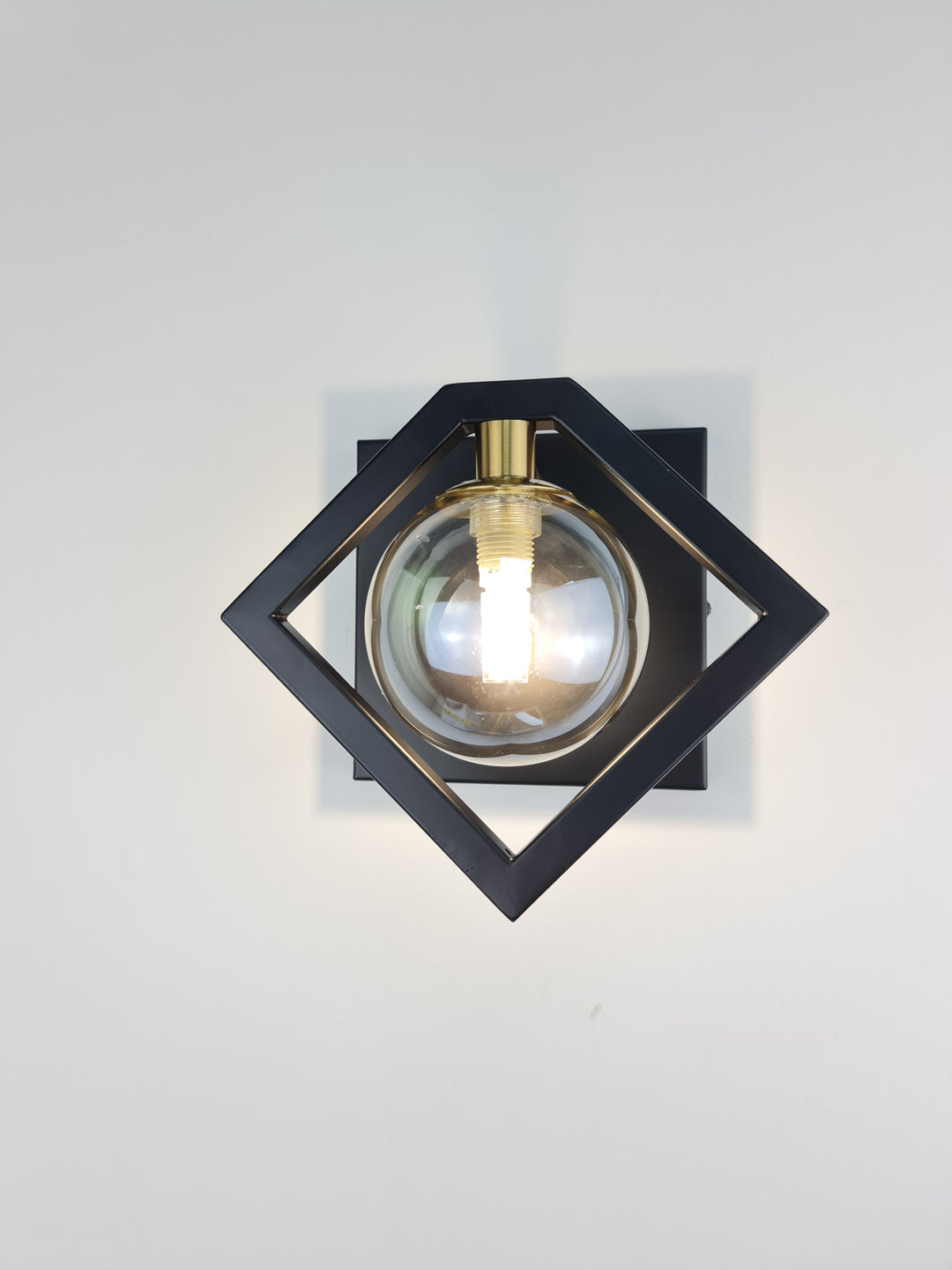 Marlow Black Wall Light With Round Amber Glass Shade